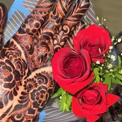 The final stain is everything. Here is a beautiful dark henna stain, perfectly complemented by red roses. This is the quality your clients will pay for.