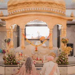 The couple sits before the Guru Granth Sahib during their Anand Karaj ceremony. A moment of peace, devotion, and spiritual union.