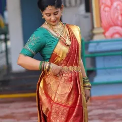 A full view of Pavithra's traditional attire. The makeup and hair are designed to hold up throughout the long day of ceremonies while looking elegant and authentic.
