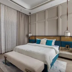 We designed this daughter’s bedroom with a soft, soothing palette and thoughtful detailing. The wall is treated with classic molding, while the custom headboard combines a teal velvet base with a cane panel, adding a touch of youthful freshness to the elegant space.