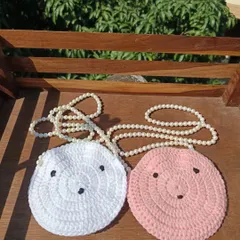 Adorable round sling purses with cute faces and pearl straps. I can make these in a variety of colors for bulk orders.