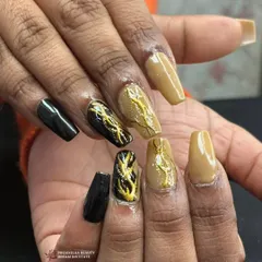 An edgy and modern design combining solid black, a neutral tan, and abstract black nails with a raised gold texture that looks like molten metal.