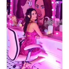 Embracing the Barbiecore trend for a themed party. This look is all about fun, with a shimmery pink dress and a bright, glowing makeup look to match.