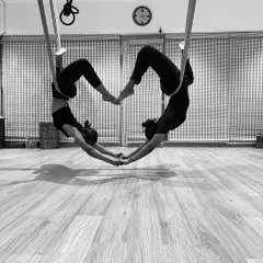 Another take on our partner heart pose, showing the beautiful shapes we can create together. This is a favorite in our partner aerial yoga workshops.