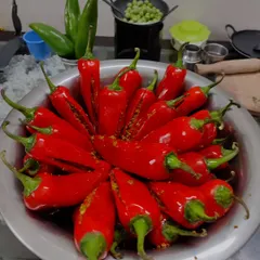 A bowl of bright red chillies, slit and filled with my special spice blend. This is the first step in making the famous Banarasi-style bharva lal mirch achar.