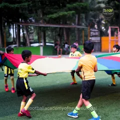 Teamwork makes the dream work, even in fun drills. Players use a parachute to learn coordination and cooperation.