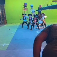 Here you can see the technical setup with a camera crane and green screen. I choreographed this sequence for a group of male models, incorporating props and puppetry into the performance.