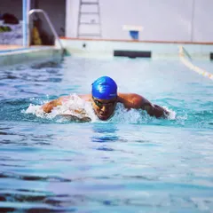 An action shot capturing the power phase of the butterfly stroke. I teach my students how to use their whole body to generate momentum, which is essential for advanced swimming techniques.