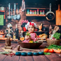 This little one is tasting her leafy greens during her 'Little Chef' photoshoot. I use a variety of real and safe props to make the experience sensory and fun, leading to authentic expressions.