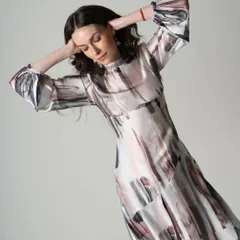 A fashion catalogue image capturing the flow and pattern of a printed dress. Movement is used here to show the fabric's texture and how it drapes.