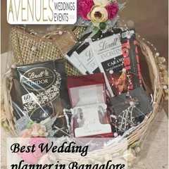 This wicker gift basket combines luxury chocolates with fine jewelry. It's a perfect example of a personalized hamper for a bride, combining her favorite treats with a special gift.