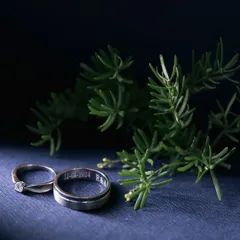 A beautifully styled shot of the wedding bands, engraved with the special date. We take care to capture these small but significant details in an artistic way.