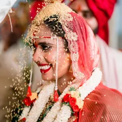The bride's blissful smile during the 'talambralu' ritual. Our candid photography freezes these fleeting moments of pure happiness.