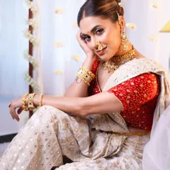 A full-length shot from the "Apsara" themed shoot, showing the complete look with the elegant saree drape and regal pose.