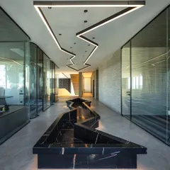 For this algorithmic trading house, I created a central passage that is both functional and artistic. The zigzagging black marble seating is mirrored by a custom overhead lighting fixture, guiding movement through the space while reflecting the dynamic nature of the business.