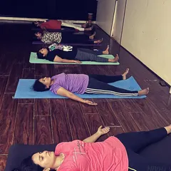 A moment of deep relaxation in Savasana, or corpse pose, at the end of a class. This is where the body absorbs the benefits of the practice, guided by gentle instruction and stillness.