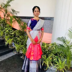 A full view of the pink and silver half-saree lehenga. The combination of a traditional skirt with an embroidered blouse and modern dhavani is very popular.