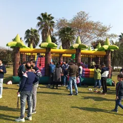 A wide shot of the jungle bouncy castle at a corporate family day, showing how it can entertain a large group of children and adults at once.