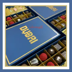 A close-up of our "Dubai" branded corporate chocolate box. The rich blue and gold combination exudes luxury, while the chocolates inside are a delightful treat.