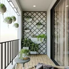A bright and airy balcony with a vertical garden trellis. This design uses hanging planters and a small seating area to create a charming green space, even in a compact apartment.