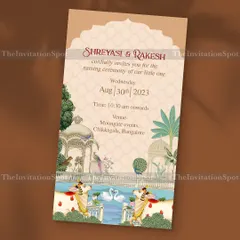 A Pichwai theme naming ceremony invite that is rich in tradition and artistry. The design features beautiful cows, swans, and architectural elements inspired by classic Pichwai paintings.