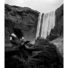 An artistic black and white photo that focuses on the wild, untamed feel of the wind catching Shree's hair and the fabric of her gown.