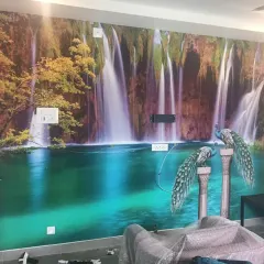 This waterfall mural turns a living room wall into a tranquil natural scene. I ensure the image is perfectly aligned and trimmed around switchboards for a clean, uninterrupted view.