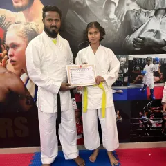 With one of our students after she received her certificate. Mentoring and guiding our fighters on their journey is our primary role.