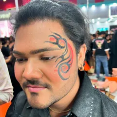 This tribal-inspired design is a great example of face art for men. The sharp lines and red accents create a powerful and masculine look that's perfect for a variety of events.