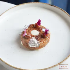 The Doughnut Kebab, plated and ready to be served. It’s a dish that perfectly balances rich, traditional flavors with a modern, whimsical form.