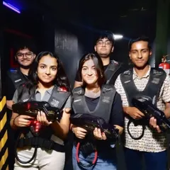 This group is all smiles before their laser tag game. It's a great activity for friends to team up or face off.
