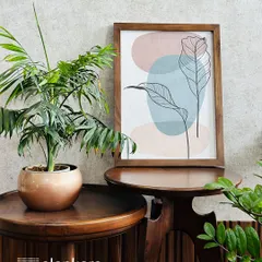 My custom wall art service allows you to transform your space with sophistication. This abstract leaf line art, set in a simple wooden frame, adds a touch of modern, organic beauty.