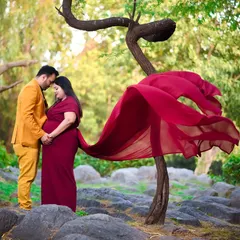 An intimate moment between partners during an outdoor shoot. The way they hold each other and the baby bump shows the love and excitement you share.