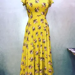 A custom-stitched long floral dress in yellow. This anarkali-style dress has a simple neckline and flutter sleeves, with a focus on perfect fitting.