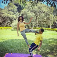 Look Ma, no hands! This playful moment captures the fun and occasional panic of learning a new Acro Yoga pose. It’s not about perfection, but about the joy of trying.