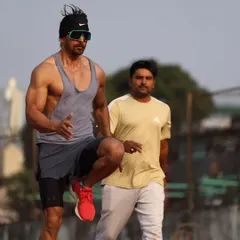 I believe in being on the track with my clients, observing every move. Here I am watching Harshvardhan Rane's form during a running drill to provide immediate feedback.
