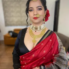A modern reception look with a classic touch. I created a sharp winged eyeliner and a bold red lip to pair with her beautiful red and black saree. This photo is completely unedited to show the real texture of the makeup.