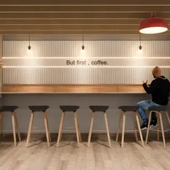 "But first, coffee." This detail shot from our cafeteria concept shows a dedicated coffee bar with sleek stools, designed as a quick pit-stop for refreshment and casual conversation.