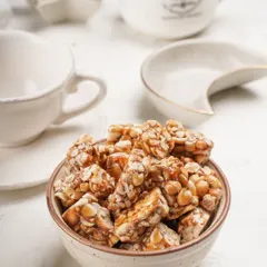 A close up look at my homemade peanut chikki. You can see the texture from the whole peanuts and the natural glaze from the jaggery. This is what real, preservative free chikki looks like.