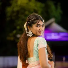 A classic over-the-shoulder portrait. Her glance towards the camera is captivating, and the night lighting adds a touch of glamour to this traditional look.