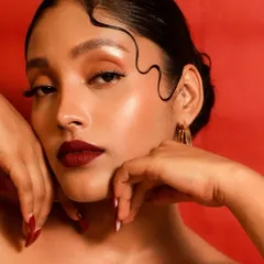 The sleek, wet-look hair detail adds a modern, editorial edge to the classic Hollywood glamour.