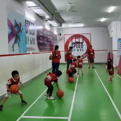 Another angle of our basketball dribbling practice. The kids are spread out, each with their own ball, ensuring maximum practice time and engagement during the activity.