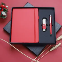 We deliver clean, sharp product photography for corporate merchandise. This image of a premium red gift set, containing a notebook, pen, and USB drive, is an example of our catalog-ready shots, presented in its packaging for a professional look.