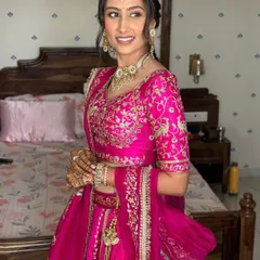 A radiant smile for a vibrant pre-wedding function. This Myra ceremony look features a soft-focus base, a sun-kissed glow, and a nude glossy pout for effortless elegance.