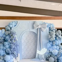 Celebrating a 'Baby in Bloom' with this premium and elegant baby shower decor. The setup features a serene all-blue color palette, a custom arched backdrop with delicate textures, and lush organic balloon garlands, creating a sophisticated and loving atmosphere for the mom-to-be.