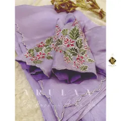 A custom organza saree and blouse set we created for a client. The lavender saree features a delicate scalloped border and is paired with a blouse that has hand-painted and embroidered floral motifs.