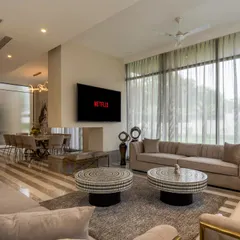 This is what a finished turnkey project feels like. In this farmhouse drawing room, I combined a serene palette of beige, white, and gold with cozy furnishings to create a space that is perfect for both elegant entertaining and relaxed family evenings.