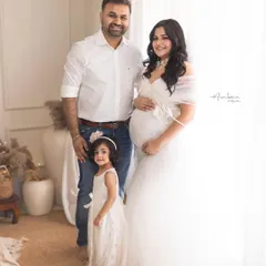 Your growing family is a beautiful story to tell. This bright, airy portrait captures the joy of welcoming a new member, with the older sibling sharing in the excitement. It’s a heartwarming family maternity photo that you will cherish forever.