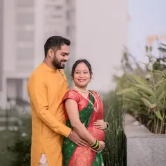A lovely maternity portrait of a couple in traditional Indian outfits. Their gentle smiles and embrace capture the peaceful joy of this special time.
