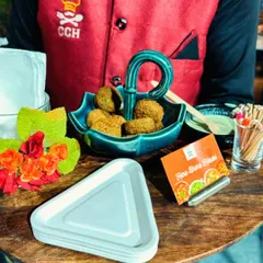 Our staff presenting a tray of Hara Bhara Kebabs. We pay attention to every detail, from the food itself to the beautiful serving dishes and presentation.